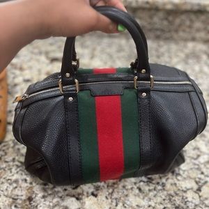 Medium size Gucci Boston bag in black.
